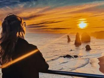 Great Ocean Road Sunset Tour Sunset view over the ocean with tourist enjoying the moment on Great Ocean Road