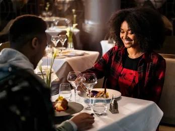 Manhattan Restaurant Two adults eating at a fine dining restaurant