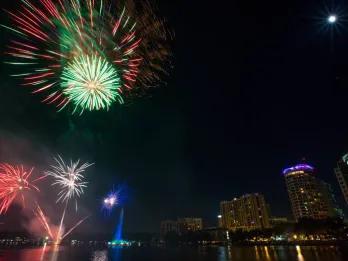 Fireworks in the sky bursting over Downtown Orlando high rise buildings.