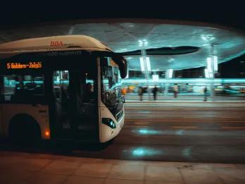 Bus at bus stop at night