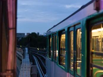 Green and white train outside.