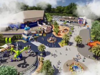 Misty theme park with spinning rides, lego statues and a large building with space theming on it.