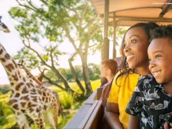 family on safari with giraffe