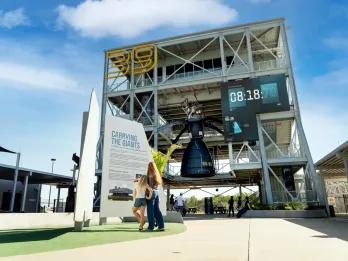 A woman and young girl standing in front of a rocket experience at Kennedy Space Center