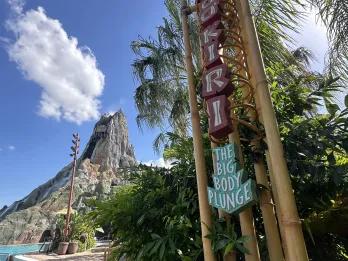 Statue of volcano in water park and there's a sign made out of tall bamboo posts and says "Ko'okiri Body Plunge"