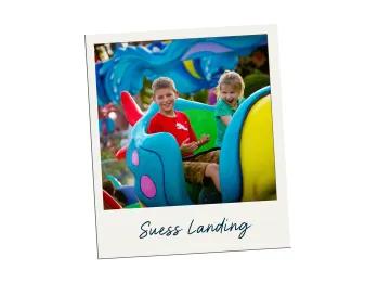 Suess Landing Two small kids sat in cartoon fish going in circle.