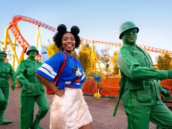 A woman marching with the Green Army Men through Toy Story Land