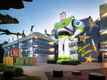 A motel-style hotel building with a giant statue of Buzz Lightyear in the centre