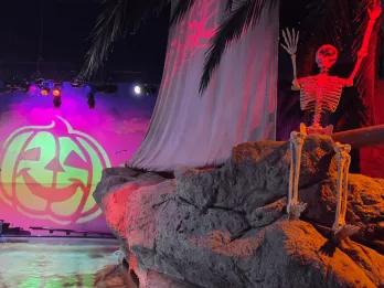 SEA LIFE  Room decorated with prop skeleton on rocks, the sea below and a pumpkin projection.