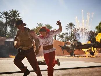 Indiana Jones and Marion running away from an exploding plane
