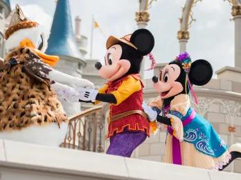 Mickey Mouse, Minnie Mouse and Donald Duck on stage in fantasy costumes