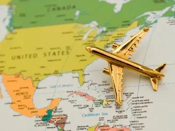 Travel to the US A small gold plane on a map of the US