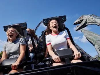 Guests laughing and screaming with excitement on the Jurassic World VelociCoaster at Universal Orlando Resort, one of the top attractions in Orlando.
