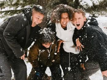 A happy family playing in the snow during a winter holiday