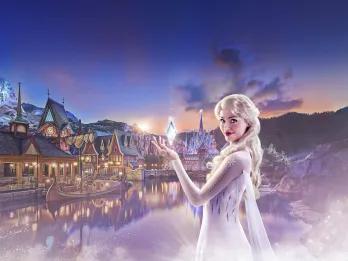 Elsa making ice with her hands stood in front of the kingdom of Arendelle