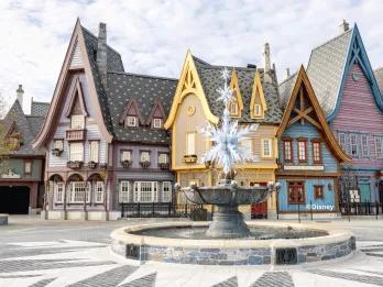 Arendelle-style buildings surround a crystalline snowflake fountain at Disneyland® Paris