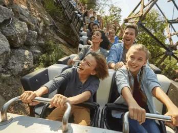A family riding on a roller coaster at PortAventura World