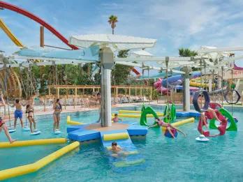 Children playing on a water obstacle course at Caribe Aquatic Park