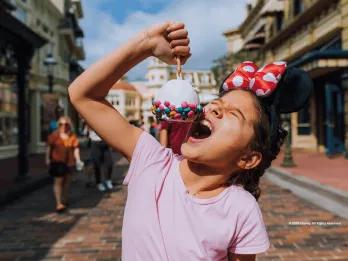 Guest on Main Street, U.S.A. eating a snack