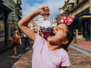 Guest on Main Street, U.S.A. eating a snack