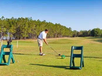 Golfer practicing at the driving range at Highlands Reserve
