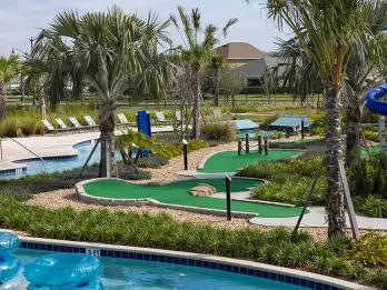 Mini golf course alongside a lazy river with blue inner tubes