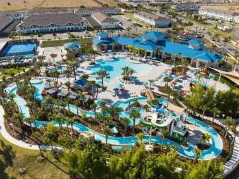 Aerial view of a resort water park with lazy river and water slides at an Orlando villa community