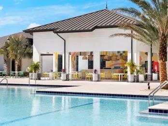 Grand pool and clubhouse lounge at Villatel Resort Orlando, a villa community near International Drive and Universal Orlando Resort