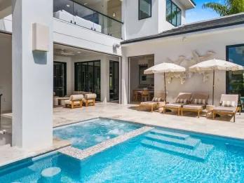 Private pool and spa with sun loungers at a luxury Orlando villa