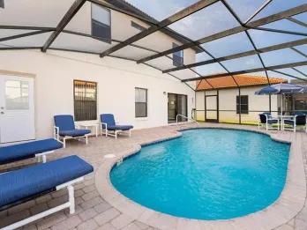Screened-in private pool with sun loungers at an affordable Orlando villa