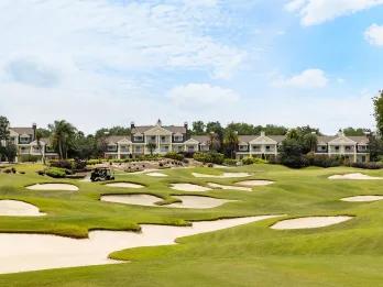 Championship golf course with sand bunkers in front of villas at Reunion Resort, Orlando