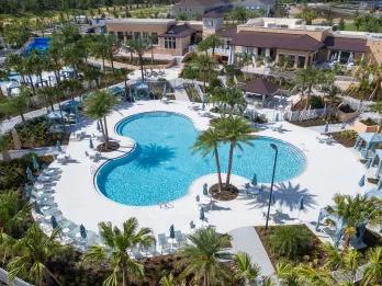 Aerial view of Solara Resort's clubhouse and pool with FlowRider water slide, a premium resort-style Orlando villa community