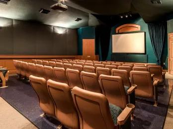 On-site movie theatre with rows of cinema seating at Windsor Palms, an Orlando villa community