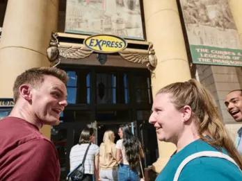 A couple standing outside the Express lane at a Universal Orlando park