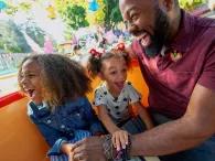 Father and daughters on Mad Tea Partym Disneyland Park in California