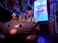 Remy's Ratatouille Adventure A family in a ride vehicle shaped like a large cartoon rat