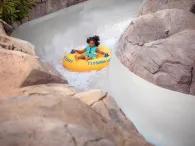 Mayday Falls A young girl on a raft going down a water slide