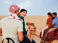 Guests enjoying a camel ride through the Dubai desert