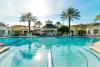Large communal pool surrounded by palm trees at Windsor Palms