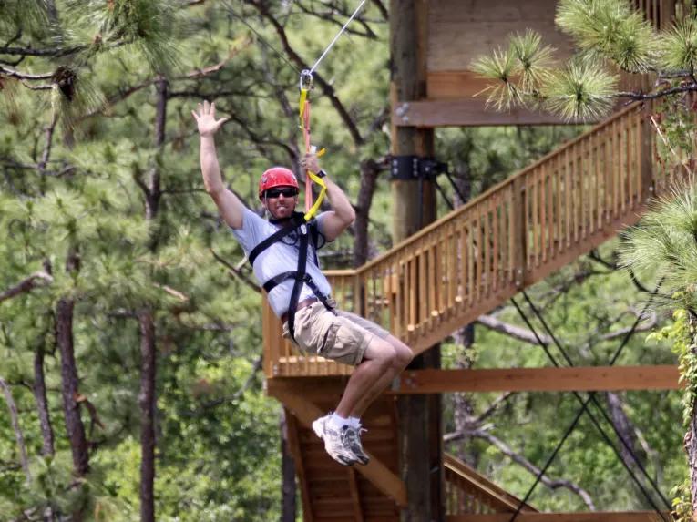 Man riding the Gator Zip Line at Gatorland Orlando