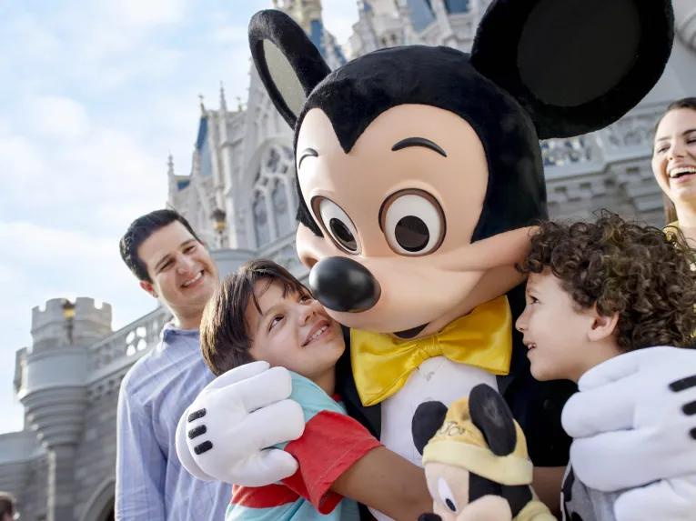 Mickey with family in front of castle at Magic Kingdom