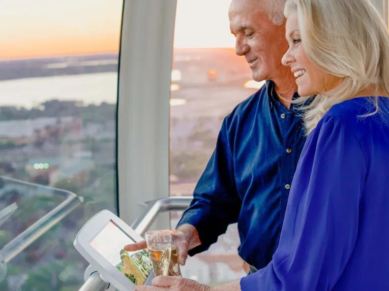 Couple enjoying champagne on the Icon Orlando Wheel