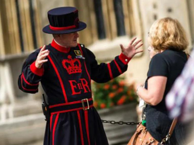 Guest listening to stories from the Beefeaters at Tower of London