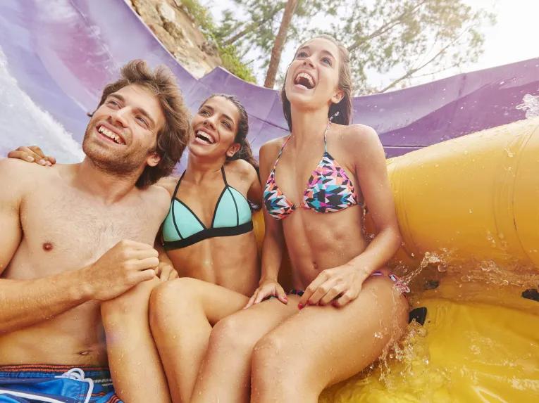 Friends riding El Torrent Water Slide at PortAventura Caribe Aquatic Park