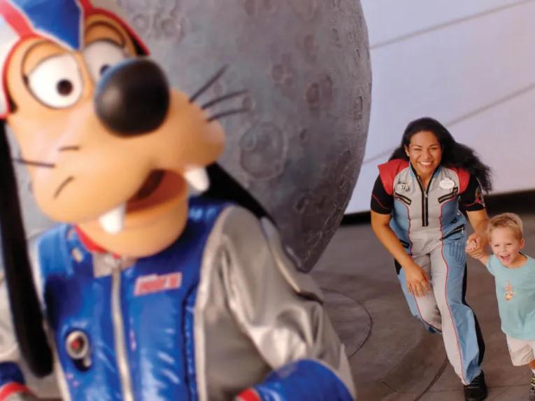 Goofy being chased by guests at Epcot