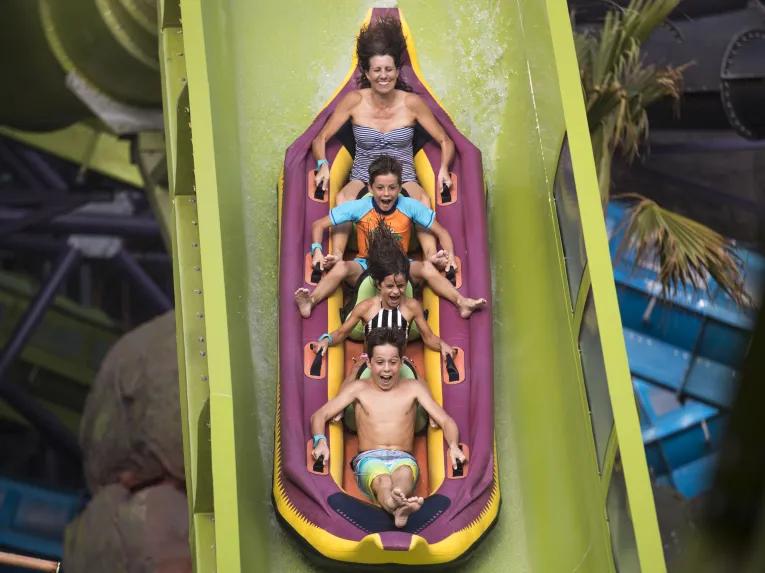 Guests riding Krakatau Aqua Coaster at Universal's Volcano Bay Water Theme Park