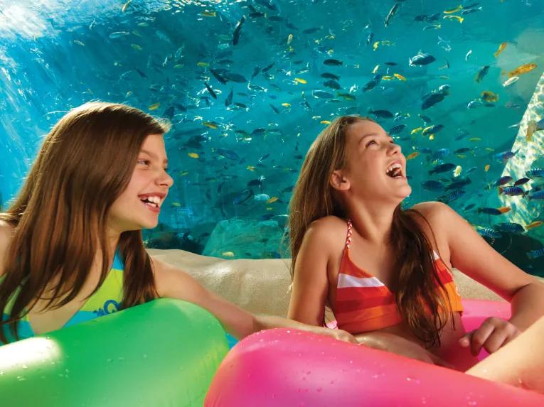 Girls floating along Loggerhead Lane at Aquatica Orlando