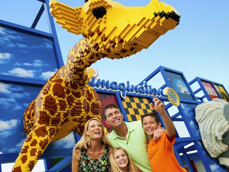 Family in front of LEGO giraffe at the entrance to the Imagination Zone at LEGOLAND Florida