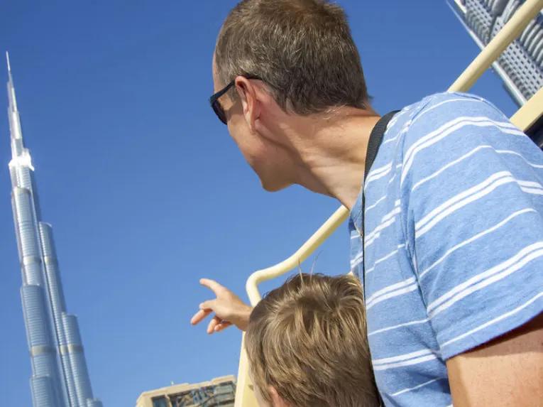 Father and son pointing to the top of the Burj Khalifa in Dubai