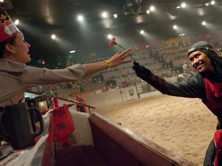 A Knight giving a rose to a lady at Medieval Times Orlando Dinner Show & Tournament